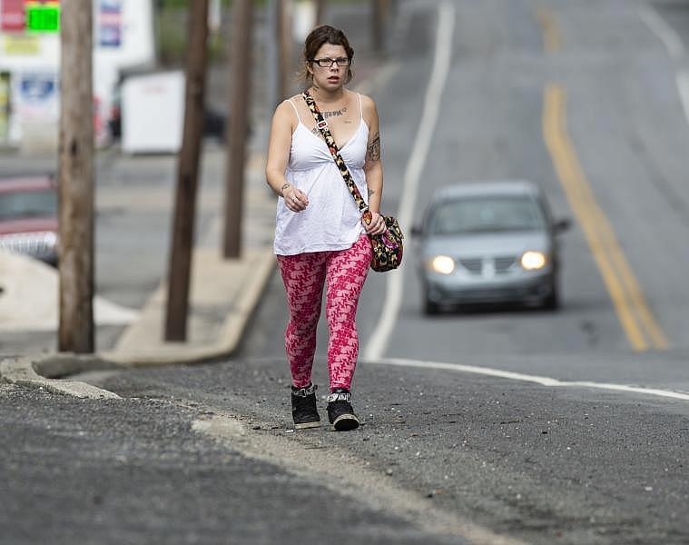 Alicia Kachmar of Lansford walks along Route 209 in Coaldale to go to nearest emergency room at St. Luke's Miners Campus to seek treatment for a toothache. Rick Kintzel / The Morning Call