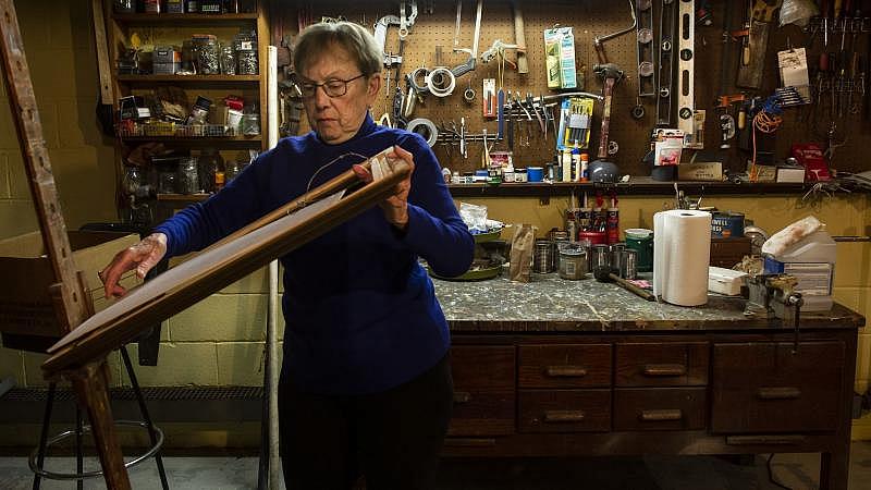 Keeping busy, Jeanne Stemler, 91, fiddles with one of her paintings as she tries to place it into a frame while in her basement in Lower Towamensing Township. Rick Kintzel / The Morning Call