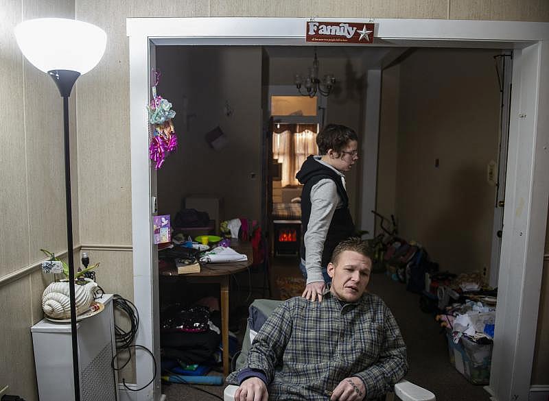 Alicia Kachmar places her hand on the shoulder of her fiancée Travis Litts in their Lansford apartment. Rick Kintzel / The Morning Call