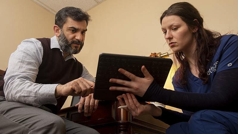 Dr. Raja Abbas, a psychiatrist, goes over data with his scribe, Angelina Catalano, at his Palmerton practice. Rick Kintzel / The Morning Call