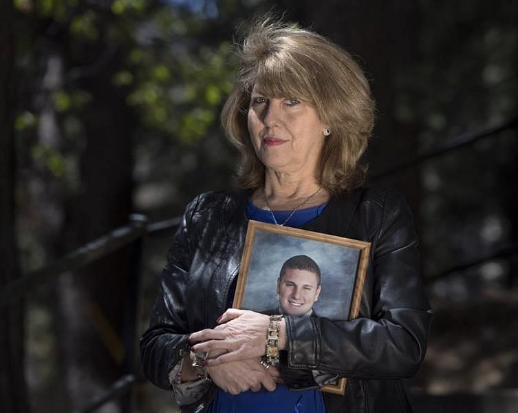Public Safety Advocate Wendy McEntyre founded the nonprofit Jarrod’s Law after her son, Jarrod Autterson, died at age 23 of an overdose in a sober living home. She holds his high school graduation photo. (Photo by Mindy Schauer, Orange County Register/SCNG)