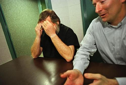 Butch Kimmerling buries his head in his hands while talking about the molestation of his adopted daughter, Ashley. Attorney John Erickson III sits nearby. (INDYSTAR FILE IMAGE)