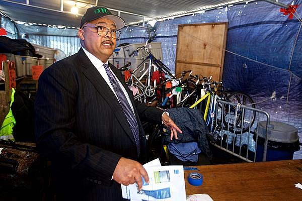 Public Works Director Mohammad Nuru stands in one of five containers filled with homeless people’s belongings seized by city workers. (Photo: Kevin N. Hume)