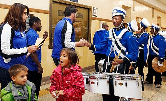 Paul Braun, co-director of the North Division High School Drumline (left) shakes Maleak Taylor's hand, before the start of the MPS Hosts City Drumline Competition at Rufus King High School. "Most freshmen come in and they act like freshmen. You don't see that from Maleak. He's a real leader and we (the drum line) will go as he goes. He's the leader," said Braun. (Photo: Angela Peterson/Milwaukee Journal Sentinel)