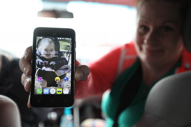 In March, on the way to a methadone clinic in Everett, Washington, Parent-Child Assistance Program client NaVey Skinner shows a photo of her daughter, who is in foster care. (Giles Bruce, The Times)