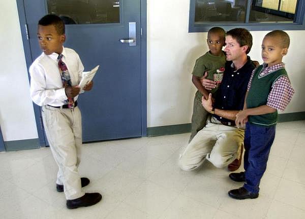 Craig Peterson and his three sons, Brandon, Michael and Andrew, visit their biological mother Kim Guiden in the Rockville Correctional Facility in Rockville, Indiana. INDYSTAR FILE IMAGE