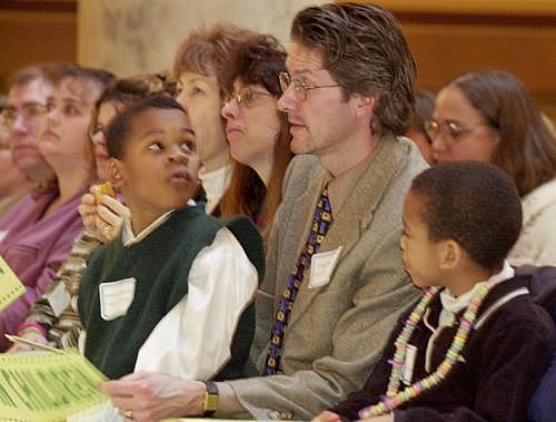 Craig Peterson, alongside his sons, Michael (right), 6, and Andrew, 7, attend a rally for children's issues at the Indiana State Capitol in 2001. (INDYSTAR FILE IMAGE)