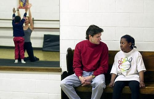 Ashley and her adoptive father Craig Peterson chat during a break in a dance class. (INDYSTAR FILE PHOTO)
