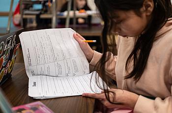 Child looking at notes
