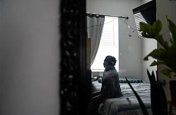 Woman sitting on bed