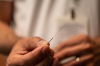 A hand with a needle