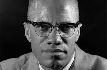 Non-colored picture depicting a person in a suit and glasses with a tie