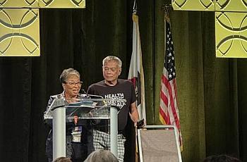 Two people at podium on stage