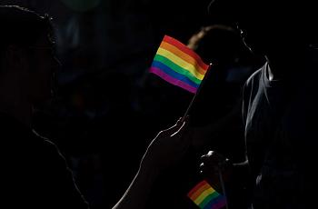 Dark background with a rainbow flag