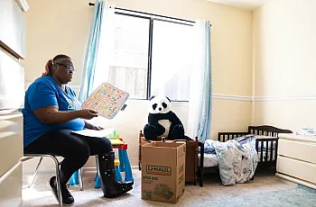 Person sitting in a room on a chair