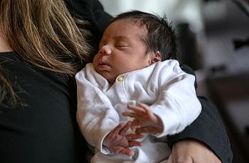 Baby in someone's arms