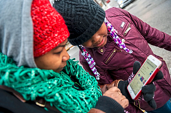 A person and a child looking at a phone