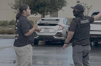 A person confronts an ICE officer 
