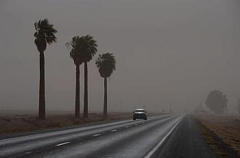 A car on a road, visible through a fog