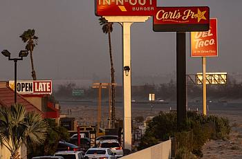 Cars wait in a queue amid several fast food restaurants in Southern California.