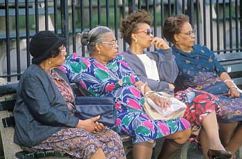 Four women on a park bench