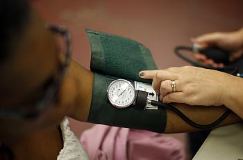 A woman has her blood pressure taken.