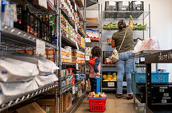 A family gathers food in the community pantry at the Central Texas Food Bank.