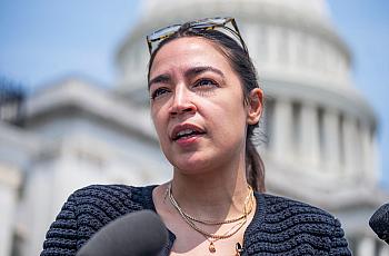Rep. Alexandria Ocasio-Cortez talks with reporters outside the U.S. Capitol in July.
