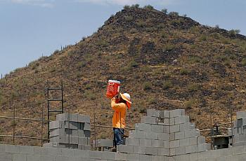 A worker standing betwen bricks 
