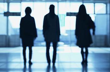 Three women in silhouette.
