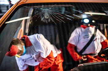 crash test dummies in a car with broken wind shield