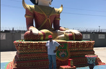 Person standing in front of a large statue