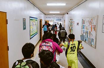 Children walking in the school aisle