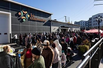 People waiting in line to pick up food 