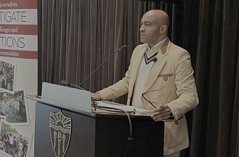 Lee Hawkins speaks at a podium.