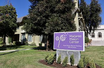 Purple sign surrounded by grass