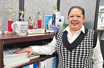 A woman stands in her office