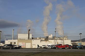 building with smoke coming out of chimneys/vents