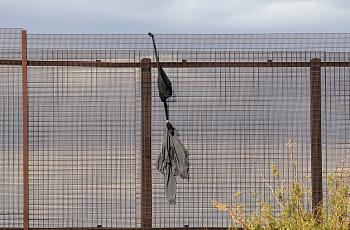 A sweatshirt dangles the border wall between Ciudad Juarez, Mexico, and El Paso, United States. 