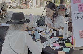 Two people taking at a community event