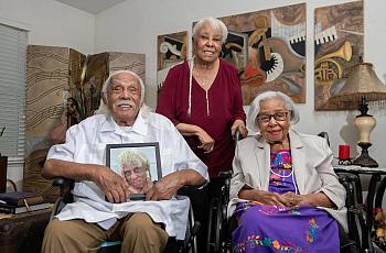 Three people, two seated