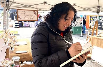 A Fresno vendor and breast cancer survivor Ana Barraza writes up a sale for a customer