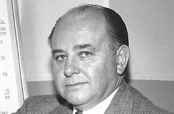 Black and white picture of a person wearing a suit