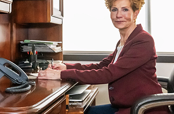 Person seated in front of a table