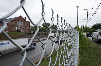 Road visible through a fence