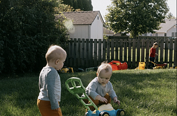 2 children playing in grass