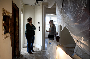 People in a house covered in tarp