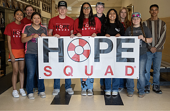 Group of people holding a 'Hope Squad' sign