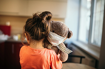 child holding a teddy bear