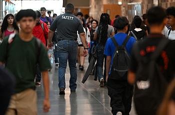People walking through a crowded hallway